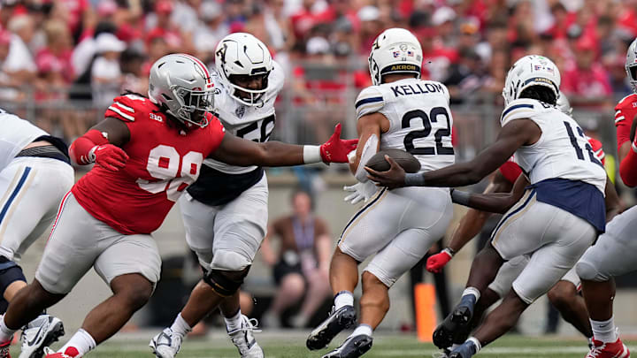 Aug 31, 2024; Columbus, OH, USA; Ohio State Buckeyes defensive lineman Kayden McDonald (98) reaches out as Akron Zips quarterback Tahj Bullock (12) mishandles a handoff to running back Charles Kellom (22) during the second half of the NCAA football game at Ohio Stadium. Ohio State won 52-6.