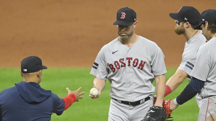 Jun 8, 2023; Cleveland, Ohio, USA; Boston Red Sox manager Alex Cora (13) takes the ball from starting pitcher Corey Kluber (28) during a pitching change in the eighth inning against the Cleveland Guardians at Progressive Field. Mandatory Credit: David Richard-Imagn Images