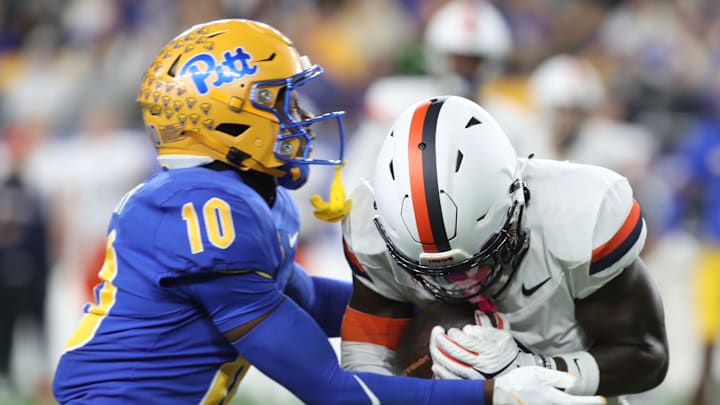 Nov 9, 2024; Pittsburgh, Pennsylvania, USA;  Virginia Cavaliers wide receiver Andre Greene Jr. is tackled after a catch by Pittsburgh Panthers defensive back Ryland Gandy (10) during the first quarter at Acrisure Stadium. Mandatory Credit: Charles LeClaire-Imagn Images