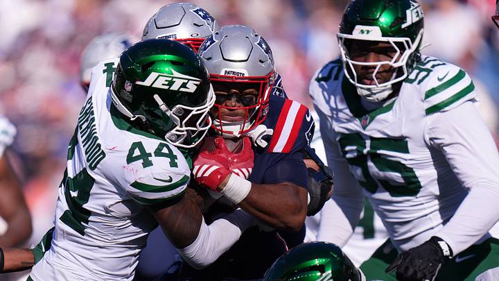 Oct 18, 2026; Foxborough, Massachusetts, USA; New England Patriots running back Treveyon Henderson (32) runs the ball against New York Jets linebacker Jamien Sherwood (44) in the second half at Gillette Stadium. Mandatory Credit: David Butler II-Imagn Images