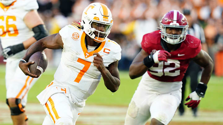 Oct 21, 2023; Tuscaloosa, Alabama, USA; Tennessee Volunteers quarterback Joe Milton III (7) scrambles with the ball against the Alabama Crimson Tide during the second half at Bryant-Denny Stadium. Mandatory Credit: John David Mercer-Imagn Images