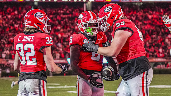 Nov 29, 2024; Athens, Georgia, USA; Georgia Bulldogs wide receiver Dominic Lovett (6) reacts with running back Cash Jones (32) and offensive lineman Tate Ratledge (69) after catching a touchdown pass against the Georgia Tech Yellow Jackets during the second half at Sanford Stadium. Mandatory Credit: Dale Zanine-Imagn Images