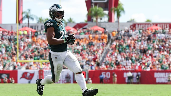 Sep 28, 2025; Tampa, Florida, USA; Philadelphia Eagles running back Saquon Barkley (26) runs with the ball for a touchdown during the third quarter against the Tampa Bay Buccaneers at Raymond James Stadium. Mandatory Credit: Nathan Ray Seebeck-Imagn Images