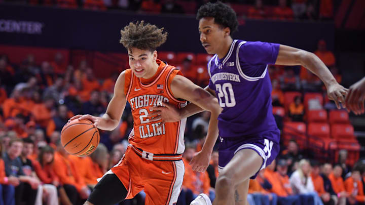 Feb 4, 2026; Champaign, Illinois, USA;  Illinois Fighting Illini guard Keaton Wagler (23) drives past Northwestern Wildcats guard Justin Mullins (20) during the first half at State Farm Center. Mandatory Credit: Ron Johnson-Imagn Images