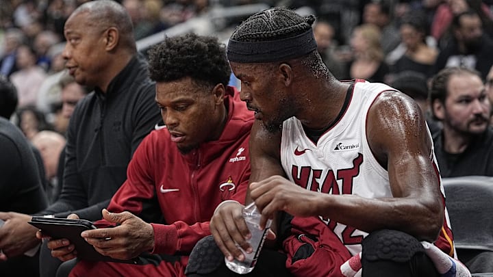 Dec 6, 2023; Toronto, Ontario, CAN; Miami Heat guard Kyle Lowry (left) and forward Jimmy Butler (right) review a play on a tablet during the first half against the Toronto Raptors at Scotiabank Arena. Mandatory Credit: John E. Sokolowski-Imagn Images
