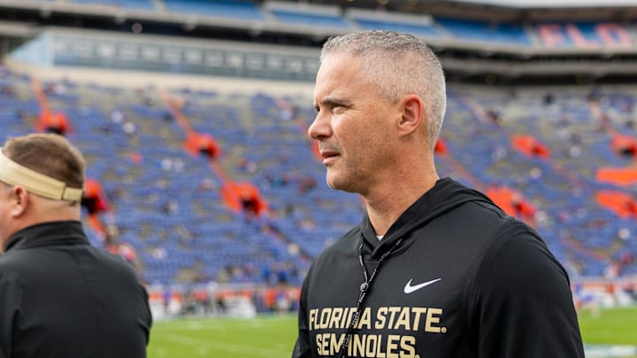Nov 29, 2025; Gainesville, Florida, USA; Florida State Seminoles head coach Mike Norvell walks the sidelines before a game against the Florida Gators at Ben Hill Griffin Stadium. Mandatory Credit: Bob Kupbens-Imagn Images
