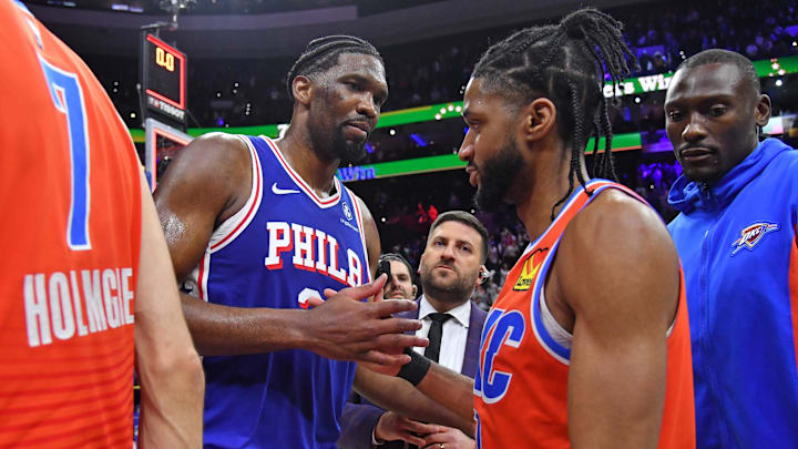 Apr 2, 2024; Philadelphia, Pennsylvania, USA; Philadelphia 76ers center Joel Embiid (21) and Oklahoma City Thunder guard Isaiah Joe (11) meet on court after 76ers win at Wells Fargo Center. Mandatory Credit: Eric Hartline-Imagn Images