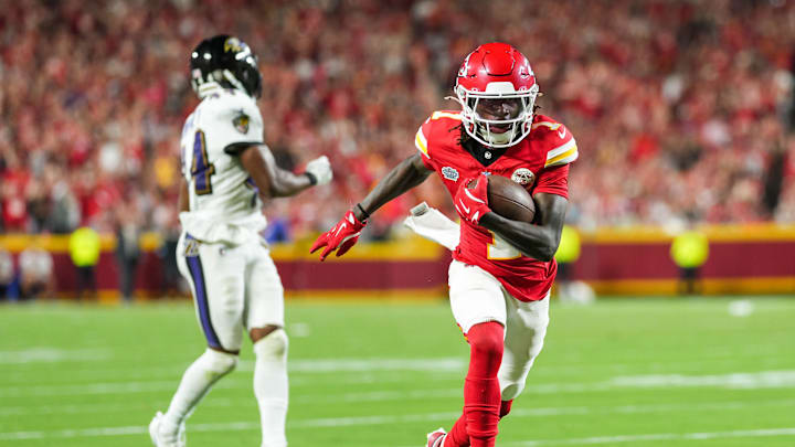 Sep 5, 2024; Kansas City, Missouri, USA; Kansas City Chiefs wide receiver Xavier Worthy (1) scores a touchdown against Baltimore Ravens cornerback Marlon Humphrey (44) during the second half at GEHA Field at Arrowhead Stadium. Mandatory Credit: Jay Biggerstaff-Imagn Images