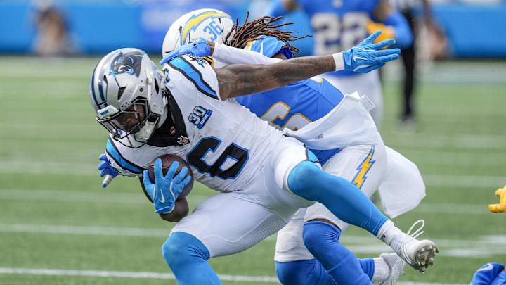 Sep 15, 2024; Charlotte, North Carolina, USA; Carolina Panthers running back Miles Sanders (6) is tackled by Los Angeles Chargers cornerback Ja'Sir Taylor (36) during the second half at Bank of America Stadium. Mandatory Credit: Jim Dedmon-Imagn Images