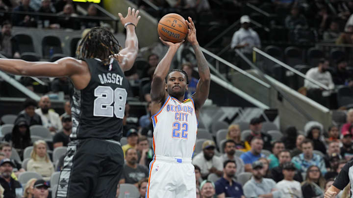 Nov 19, 2024; San Antonio, Texas, USA;  Oklahoma City Thunder guard Cason Wallace (22) shoots in front of San Antonio Spurs center Charles Bassey (28) in the second half at Frost Bank Center. Mandatory Credit: Daniel Dunn-Imagn Images