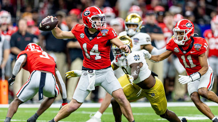 Jan 2, 2025; New Orleans, LA, USA; Georgia Bulldogs quarterback Gunner Stockton (14) passes against Notre Dame Fighting Irish defensive lineman RJ Oben (9) during the second half at Caesars Superdome. Mandatory Credit: Stephen Lew-Imagn Images Jan 2, 2025; New Orleans, LA, USA; Georgia Bulldogs quarterback Gunner Stockton (14) passes against Notre Dame Fighting Irish defensive lineman RJ Oben (9) during the second half at Caesars Superdome. Mandatory Credit: Stephen Lew-Imagn Images