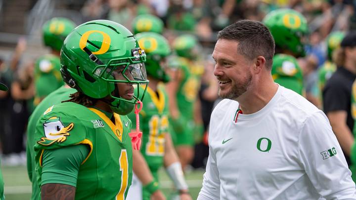 Oregon head coach Dan Lanning, right, talks with Oregon wide receiver Dakorien Moore during warmups as the Oregon Ducks host the Oklahoma State Cowboys on Sept. 6, 2025, at Autzen Stadium in Eugene, Oregon.