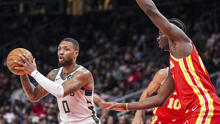 Mar 4, 2025; Atlanta, Georgia, USA; Milwaukee Bucks guard Damian Lillard (0) passes the ball in front of Atlanta Hawks center Clint Capela (15) during the first half at State Farm Arena. Mandatory Credit: Dale Zanine-Imagn Images Mar 4, 2025; Atlanta, Georgia, USA; Milwaukee Bucks guard Damian Lillard (0) passes the ball in front of Atlanta Hawks center Clint Capela (15) during the first half at State Farm Arena. Mandatory Credit: Dale Zanine-Imagn Images