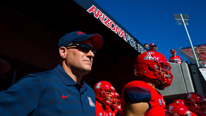 Nov 28, 2014; Tucson, AZ, USA; Arizona Wildcats head coach Rich Rodriguez (left) with his players prior to the game against the Arizona State Sun Devils during the 88th annual territorial cup at Arizona Stadium. The Wildcats defeated the Sun Devils 42-35 to win the Pac-12 south title. Mandatory Credit: Mark J. Rebilas-Imagn Images