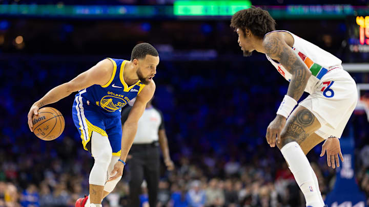 Mar 1, 2025; Philadelphia, Pennsylvania, USA; Golden State Warriors guard Stephen Curry (30) dribbles the ball against Philadelphia 76ers guard Kelly Oubre Jr. (9) during the third quarter at Wells Fargo Center. Mandatory Credit: Bill Streicher-Imagn Images
