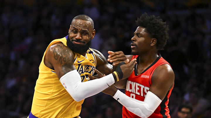 Apr 11, 2025; Los Angeles, California, USA; Houston Rockets guard Aaron Holiday (0) defends against Los Angeles Lakers forward LeBron James (23) during the first half at Crypto.com Arena. Mandatory Credit: Jonathan Hui-Imagn Images