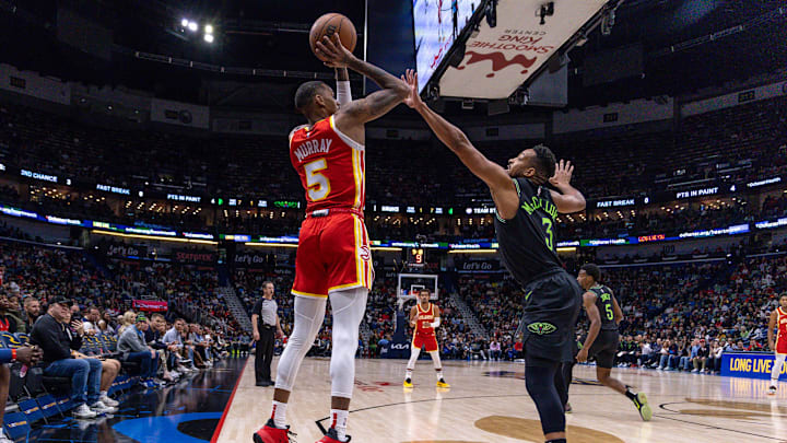 Nov 4, 2023; New Orleans, Louisiana, USA;  Atlanta Hawks guard Dejounte Murray (5) shoots a jump shot over New Orleans Pelicans guard CJ McCollum (3) during the first half at Smoothie King Center. 