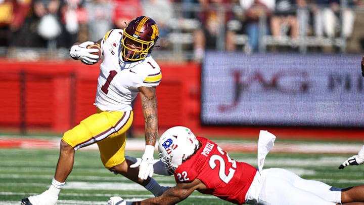 Nov 9, 2024; Piscataway, New Jersey, USA; Minnesota Golden Gophers running back Darius Taylor (1) fights for yards as Rutgers Scarlet Knights linebacker Tyreem Powell (22) tackles during the first half at SHI Stadium. Mandatory Credit: Vincent Carchietta-Imagn Images