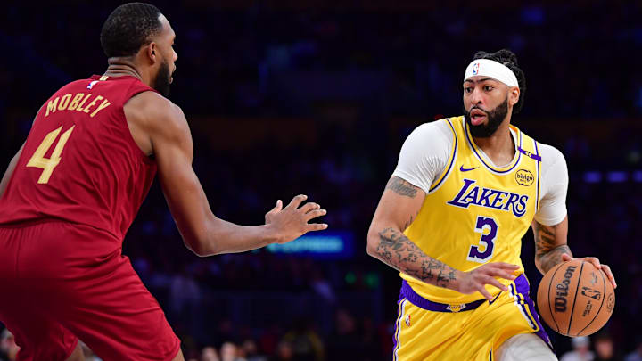 Dec 31, 2024; Los Angeles, California, USA; Los Angeles Lakers forward Anthony Davis (3) moves the ball against Cleveland Cavaliers forward Evan Mobley (4) during the first half at Crypto.com Arena. Mandatory Credit: Gary A. Vasquez-Imagn Images Dec 31, 2024; Los Angeles, California, USA; Los Angeles Lakers forward Anthony Davis (3) moves the ball against Cleveland Cavaliers forward Evan Mobley (4) during the first half at Crypto.com Arena. Mandatory Credit: Gary A. Vasquez-Imagn Images