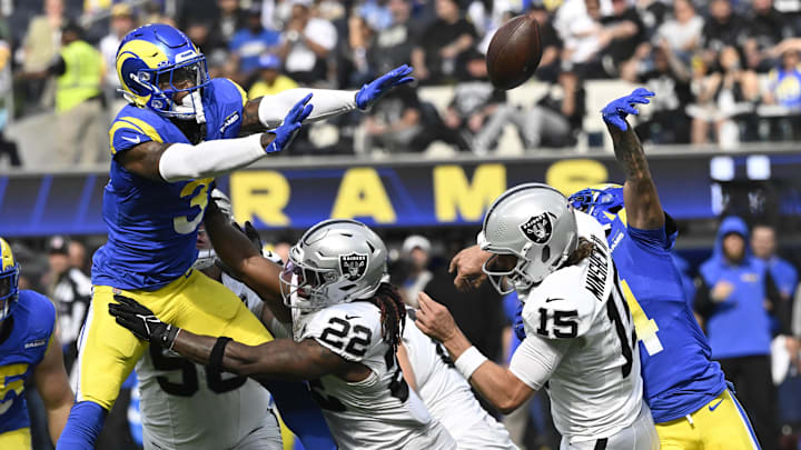 Oct 20, 2024; Inglewood, California, USA; Los Angeles Rams cornerback Cobie Durant (14) knocks the ball out of the hands of Las Vegas Raiders quarterback Gardner Minshew (15) during the second quarter at SoFi Stadium. The ball was recovered by Los Angeles Rams safety Kamren Curl (3) and runback for a touchdown. Mandatory Credit: Robert Hanashiro-Imagn Images