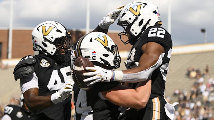 Sep 27, 2025; Nashville, Tennessee, USA;  Vanderbilt Commodores running back Makhilyn Young (22) celebrates with his teammates after scoring a touchdown against the Utah State Aggies during the second half at FirstBank Stadium. Mandatory Credit: Steve Roberts-Imagn Images