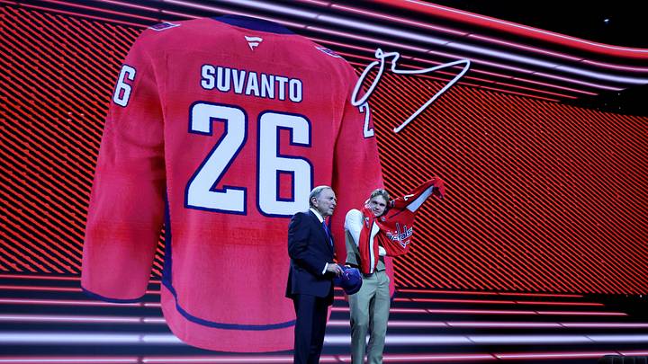 Jun 26, 2026; Buffalo, New York, USA; Oliver Suvanto reacts beside NHL commissioner Gary Bettman after being selected with the eighteenth pick in the first round of the 2026 NHL Draft by the Washington Capitals at KeyBank Center. Mandatory Credit: Timothy T. Ludwig-Imagn Images