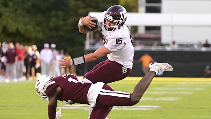Oct 19, 2024; Starkville, Mississippi, USA;  Texas A&M Aggies quarterback Conner Weigman (15) runs the ball against Mississippi State Bulldogs cornerback Brice Pollock (14) during the third quarter at Davis Wade Stadium at Scott Field. Mandatory Credit: Matt Bush-Imagn Images
