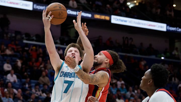 Nov 4, 2025; New Orleans, Louisiana, USA;  Charlotte Hornets guard Kon Knueppel (7) shoots against New Orleans Pelicans guard Jose Alvarado (15) during the second half at Smoothie King Center. Mandatory Credit: Matthew Hinton-Imagn Images