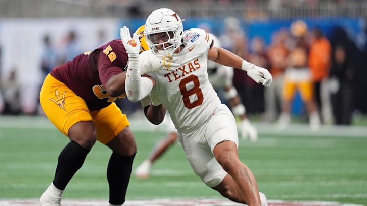 Jan 1, 2025; Atlanta, GA, USA; Texas Longhorns linebacker Trey Moore (8) runs around Arizona State Sun Devils offensive lineman Max Iheanachor (58) during the first half of the Peach Bowl at Mercedes-Benz Stadium. Mandatory Credit: Dale Zanine-Imagn Images Jan 1, 2025; Atlanta, GA, USA; Texas Longhorns linebacker Trey Moore (8) runs around Arizona State Sun Devils offensive lineman Max Iheanachor (58) during the first half of the Peach Bowl at Mercedes-Benz Stadium. Mandatory Credit: Dale Zanine-Imagn Images