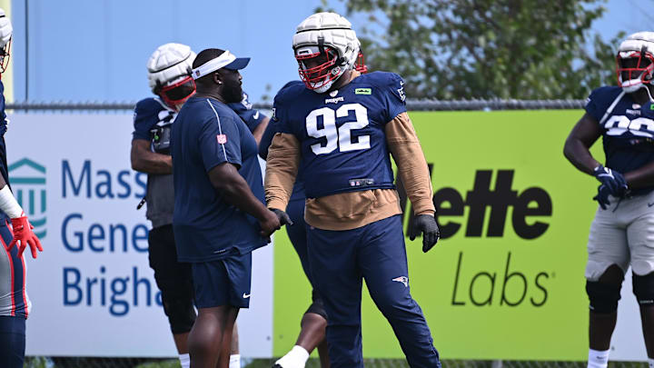Aug 03, 2024; Foxborough, MA, USA; New England Patriots defensive tackle Davon Godchaux (92) talks to coaching staff during training camp at Gillette Stadium. Mandatory Credit: Eric Canha-Imagn Images