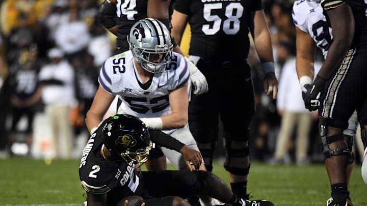 Oct 12, 2024; Boulder, Colorado, USA; Colorado Buffaloes quarterback Shedeur Sanders (2) is sacked by Kansas State Wildcats defensive end Ryan Davis (52) during the second half at Folsom Field. Mandatory Credit: Christopher Hanewinckel-Imagn Images