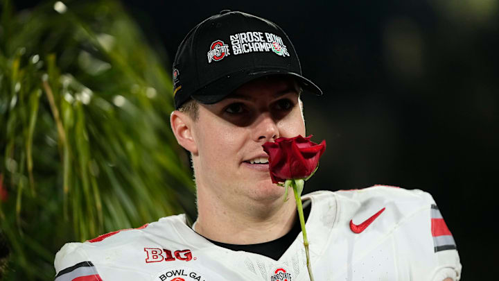 Ohio State Buckeyes quarterback Will Howard (18) smells a rose following the 41-21 win over the Oregon Ducks in the College Football Playoff quarterfinal at the Rose Bowl in Pasadena, Calif. on Jan. 1, 2025.