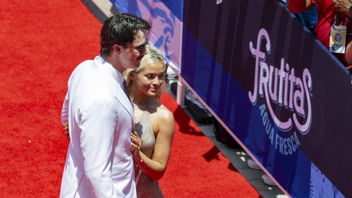 National League pitcher Paul Skenes of the Pittsburgh Pirates walks the red carpet with his girlfriend LSU gymnast Olivia Livvy Dunne before the 2024 MLB All-Star game at Globe Life Field on July 16, 2024.