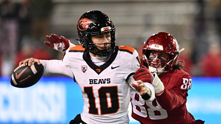 Nov 29, 2025; Pullman, Washington, USA; Oregon State Beavers quarterback Tristan Ti'A (10) gets his pass away before being sacked by Washington State Cougars defensive end Isaac Terrell (88) in the second half at Gesa Field at Martin Stadium. Washington State Cougars won 32-8. Mandatory Credit: James Snook-Imagn Images