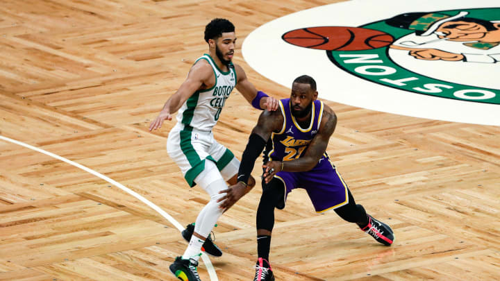 Jan 30, 2021; Boston, Massachusetts, USA; Los Angeles Lakers forward LeBron James (23) passes around Boston Celtics forward Jayson Tatum (0) during the fourth quarter at TD Garden. Mandatory Credit: Winslow Townson-USA TODAY Sports