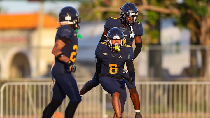 Naples Golden Eagles players celebrate with defensive back Andre Ferdinand (6) after his interception during the first quarter of a spring football game against the Venice Indians at Staver Field in Naples, Fla., on Tuesday, May 20, 2025.