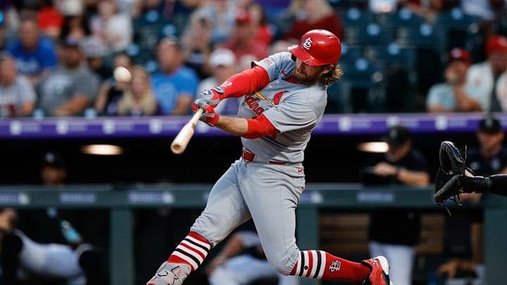 Jul 21, 2025; Denver, Colorado, USA; St. Louis Cardinals second baseman Brendan Donovan (33) hits a sacrifice fly RBI in the sixth inning against the Colorado Rockies at Coors Field. Mandatory Credit: Isaiah J. Downing-Imagn Images
