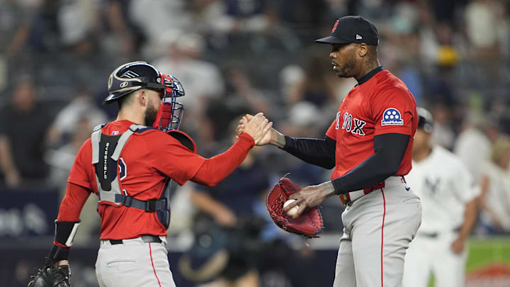 Aug 22, 2025; Bronx, New York, USA; Boston Red Sox manager Alex Cora (13) and pitcher Aroldis Chapman (44) shake hands to celebrate the victory against the New York Yankees after the ninth inning at Yankee Stadium. Mandatory Credit: Gregory Fisher-Imagn Images