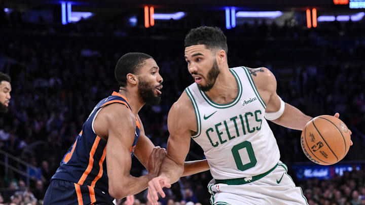 Boston Celtics forward Jayson Tatum drives to the basket while being defended by New York Knicks forward Mikal Bridges. Mandatory Credit: John Jones-Imagn Images