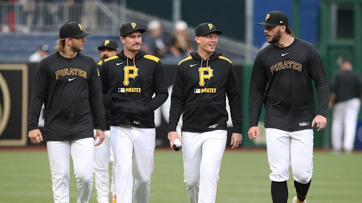 May 20, 2025; Pittsburgh, Pennsylvania, USA; Pittsburgh Pirates starting pitchers (L to R) Carmen Mlodzinski (50), Andrew Heaney (45), Mitch Keller (23) and Paul Skenes (30) walk in from the bullpen before the game against the Cincinnati Reds at PNC Park. Mandatory Credit: Charles LeClaire-Imagn Images