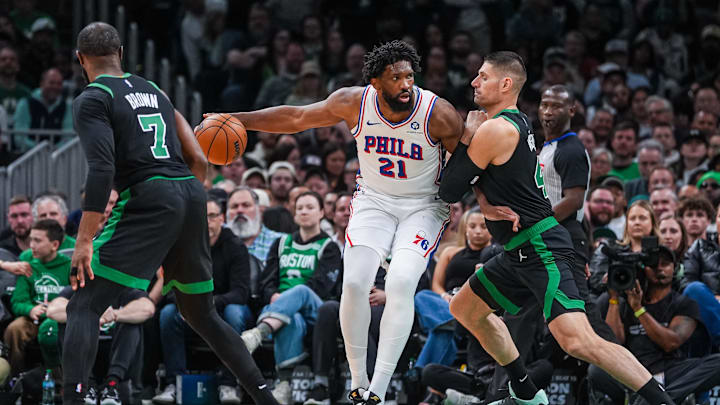 Apr 28, 2026; Boston, Massachusetts, USA; Philadelphia 76ers center Joel Embiid (21) moves the ball against Boston Celtics center Nikola Vucevic (4) in the second half during game five of the first round of the 2026 NBA Playoffs at TD Garden. Mandatory Credit: David Butler II-Imagn Images
