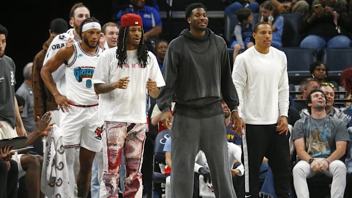 Apr 13, 2025; Memphis, Tennessee, USA; Memphis Grizzlies guard Ja Morant (left), forward Jaren Jackson Jr. (middle) and guard Desmond Bane (22) look on from the bench area during the second quarter against the Dallas Mavericks at FedExForum. Mandatory Credit: Petre Thomas-Imagn Images