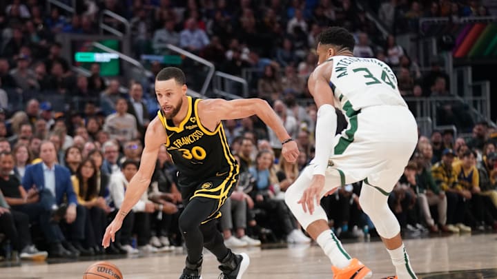 Mar 6, 2024; San Francisco, California, USA; Golden State Warriors guard Stephen Curry (30) dribbles past Milwaukee Bucks forward Giannis Antetokounmpo (34) in the third quarter at the Chase Center. Mandatory Credit: Cary Edmondson-Imagn Images