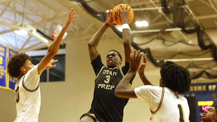 Utah Prep's AJ Dybantsa drives to the basket on Highland's Jemal Smith, left, and Josh Hamilton during a game at Emmanuel College in Boston on Tuesday, Nov. 5, 2024.