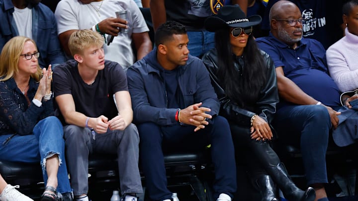 Broncos QB Russell Wilson (center) seated court-side at 2023 NBA Finals - Game Five