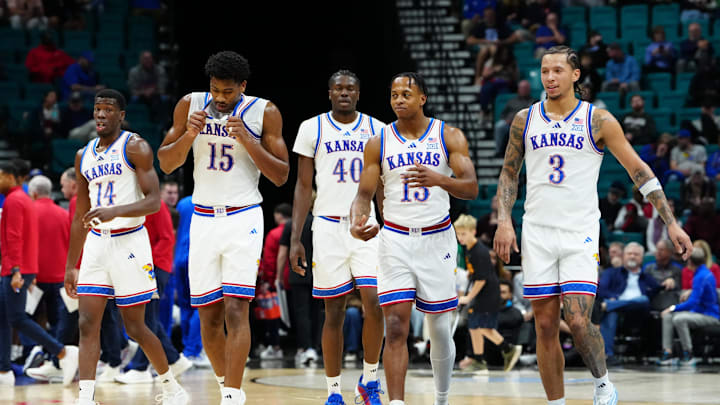 Nov 24, 2025; Las Vegas, Nevada, USA; Kansas Jayhawks guard Melvin Council Jr. (14), forward Bryson Tiller (15), forward Flory Bidunga (40), guard Elmarko Jackson (13) and guard Tre White (3) walk back onto the court after a timeout against the Notre Dame Fighting Irish during the first half in a 2025 Players Era Festival group play game at MGM Grand Garden Arena. Mandatory Credit: Stephen R. Sylvanie-Imagn Images