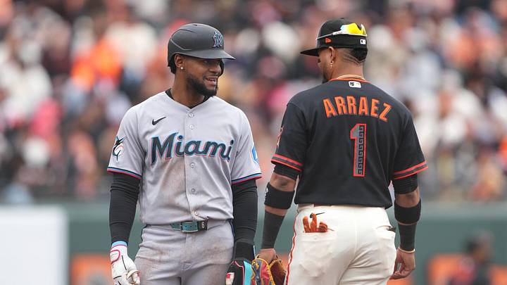 Apr 25, 2026; San Francisco, California, USA; Miami Marlins shortstop Otto Lopez (left) talks with San Francisco Giants second baseman Luis Arraez (1) during the first inning at Oracle Park. Mandatory Credit: Darren Yamashita-Imagn Images