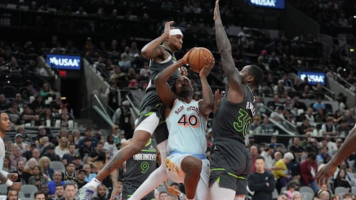 Dec 15, 2024; San Antonio, Texas, USA; San Antonio Spurs forward Harrison Barnes (40) goes in for a shot between Minnesota Timberwolves forwards Jaden McDaniels (3) and Julius Randle (30) in the second half at Frost Bank Center. Mandatory Credit: Daniel Dunn-Imagn Images Dec 15, 2024; San Antonio, Texas, USA; San Antonio Spurs forward Harrison Barnes (40) goes in for a shot between Minnesota Timberwolves forwards Jaden McDaniels (3) and Julius Randle (30) in the second half at Frost Bank Center. Mandatory Credit: Daniel Dunn-Imagn Images