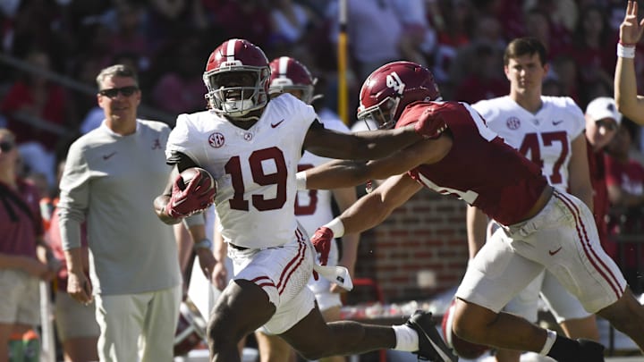 Apr 13, 2024; Tuscaloosa, AL, USA;  Alabama wide receiver Kendrick Law (19) is shoved out of bounds by  defensive player Justin Okoronkwo (41) at Bryant-Denny Stadium. Mandatory Credit: Gary Cosby Jr.-Imagn Images