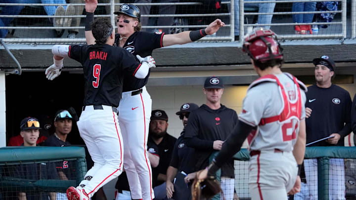 Georgia infielder Kolby Branch (9) celebrates with a teammate after hitting a home run during a NCAA baseball game against Arkansas in Athens, Ga., on Friday, April 11, 2025. Georgia infielder Kolby Branch (9) celebrates with a teammate after hitting a home run during a NCAA baseball game against Arkansas in Athens, Ga., on Friday, April 11, 2025.